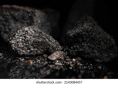 Macro Close Up Image Of Raw Material Platinum And Chrome Ore Rock Isolated On Black Reflective Background