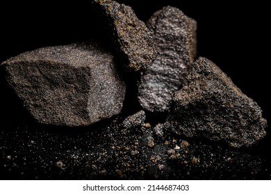 Macro Close Up Image Of Raw Material Platinum And Chrome Ore Rock Isolated On Black Reflective Background