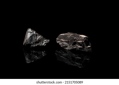 Macro Close Up Image Of Raw Material Manganese Ore Rock Isolated On Black Reflective Background