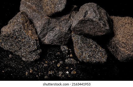 Macro Close Up Image Of Raw Material Platinum And Chrome Ore Rock Isolated On Black Reflective Background