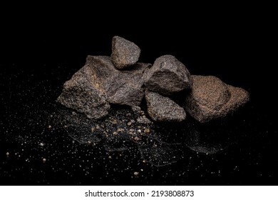 Macro Close Up Image Of Raw Material Platinum And Chrome Ore Rock Isolated On Black Reflective Background