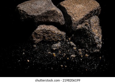 Macro Close Up Image Of Raw Material Platinum And Chrome Ore Rock Isolated On Black Reflective Background