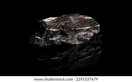 Macro Close up image of raw material Manganese Ore rock isolated on black reflective background