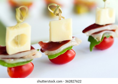 Macro Close Up Of Mini Duck Ham, Cheese And Cherry Tomato Appetizers Mounted On Skewers.   