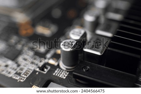 Macro close up of a modern computer gaming motherboard and graphics adaptor circuit parts