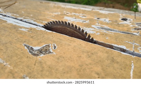 Macro Close Up of Old Rusty Circular Saw Blade Mounted on Weathered Wooden Table Workbench