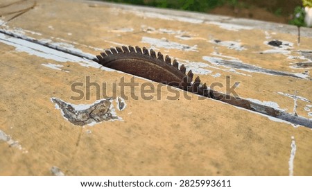 Macro Close Up of Old Rusty Circular Saw Blade Mounted on Weathered Wooden Table Workbench