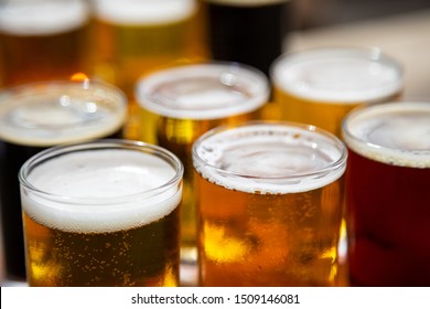 Macro Close Up On A Flight Of Craft Beer In Small Taster Glasses, With Space For Text On Top