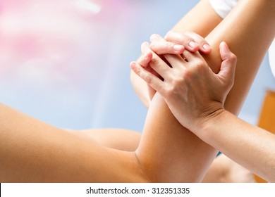 Macro Close Up Of Osteopath Massaging Female Calf Muscle. Hands Manipulating Lower Leg Muscle.