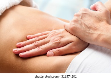 Macro close up of Osteopathic belly massage.