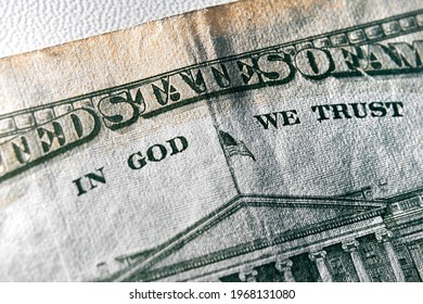 A Macro Close Up Photo Emphasizing The Inscription In God We Trust Printed On The Back Of A United States Ten Dollar Bill With Selective Focus On The Words In God We Trust.