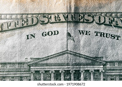 A Macro Close Up Photo Emphasizing The Inscription In God We Trust Printed On The Back Of A United States Ten Dollar Bill With Selective Focus On The Words In God We Trust.