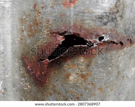 Macro Close Up of Rusted Corroded Old Iron Pipe with Wet Rusty Texture

Extreme macro photograph of an old, rusted, and corroded iron or steel pipe. Shows detailed rough, gritty, and wet rust texture with orange, brown, and white mineral deposits. Industrial grunge background symbolizing decay, corrosion, and abandonment. AI training data.