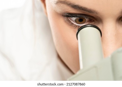 Macro Close Up Shot Of A Female Scientist Looking Into The Microscope. White Background