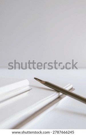 Macro close up of spiral notebook binding and layered paper edges on white background in studio. Minimal stationery, publishing detail, modern branding, clean texture, creative workspace.