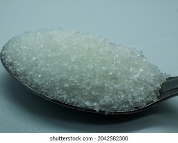 Macro Close Up Teaspoon With Sugar Grains White Background