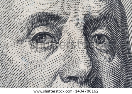 Macro close up of the US 100 dollar bill. Extreme macro. Benjamin Franklin eyes as depicted on the bill.
