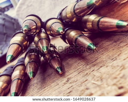 A macro close up view of a row of regular army brass and copper bullets.
