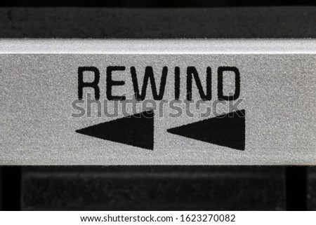 Macro close up view of vintage boombox cassette tape machine rewind button detail.
