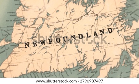 Macro close up of a vintage map highlighting Newfoundland in Canada, showcasing detailed cartography, coastal settlements, Atlantic geography, and classic antique textures ideal for travel, history, and navigation themes.