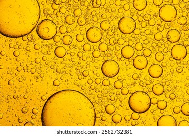 Macro close up of yellow bubble texture,Macro microscope yellow bubble texture, Close-up Yellow bubbles and drops oil background . golden Yellow water bubbles, close up golden oil drop for celebration