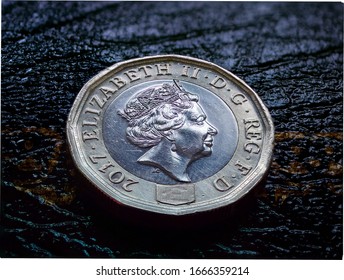 Macro closeup of 2017 British pound coin.  
This coin has an image like a hologram that changes from a ‘£’ symbol to the number '1' when seen from different angles and tiny lettering on the inside rim - Powered by Shutterstock