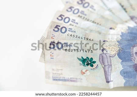 Macro closeup of 50 thousand Colombian pesos bills on white background