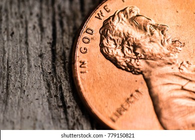 A macro closeup of an Abraham Lincoln penny on a plain background. - Shutterstock ID 779150821