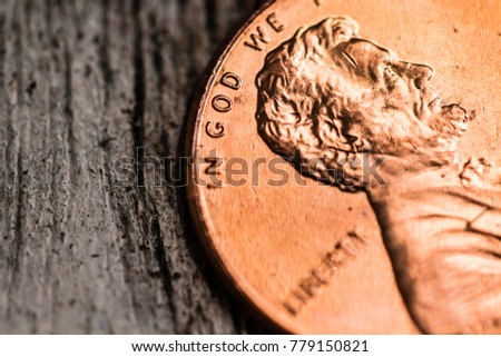 A macro closeup of an Abraham Lincoln penny on a plain background.