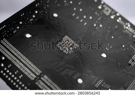 Macro close-up of the back side of a computer motherboard featuring printed circuit board traces and electronic solder points, representing PCB engineering, digital technology, hardware design and electronics manufacturing.