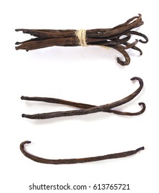 macro closeup of a bunch delicious fresh vanilla dark brown beans pods sticks isolated on white