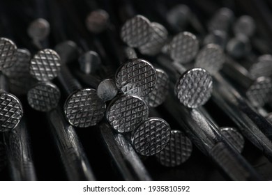 macro closeup bunch of metal silver aluminium nails hardware assorted in black minimal background