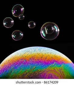 Macro closeup of a colorful soap bubble isolated on black
