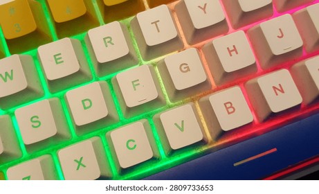 A macro close-up of a custom mechanical keyboard focusing on the prominent orange Enter key and white Shift key. Illuminated by a vibrant neon purple and pink RGB LED backlight, this colorful peripheral layout represents digital execution, computer programming, cybersecurity, and modern gaming setups.