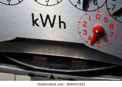 Macro Close-up Of A Domestic KWh Electric Meter And Slow Turning Measuring Dial. Concept For Energy, Utility Bills, Price Rises, Meter Reading, Inflation, Cost Of Living Crisis And Higher Fuel.