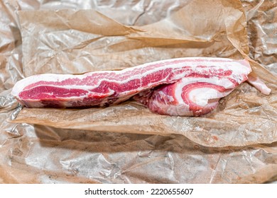 Macro Closeup Flat Top Lay Of Fresh Barbecue Uncooked Raw Pork Belly Fat Bacon Meat, Nutritious Food On Brown Paper Wrap