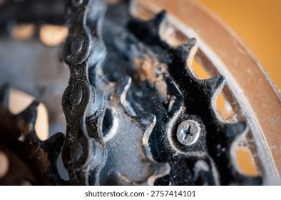 A macro close-up focused on the complex interaction between a greasy bicycle chain and worn metal cog teeth, displaying high-resolution industrial textures.