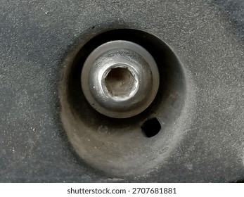 Macro Close-Up of Hex Socket Screw Head Embedded in Dark Plastic or Metal