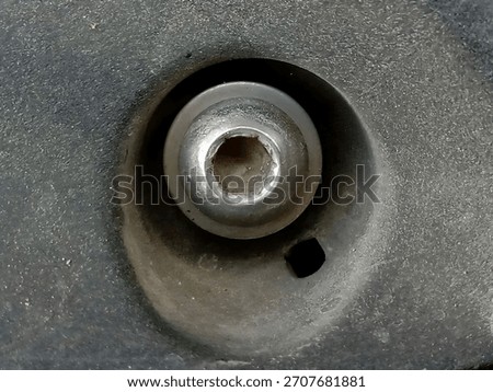 Macro Close-Up of Hex Socket Screw Head Embedded in Dark Plastic or Metal