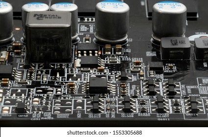 Macro close-up image of circuitry (graphics card capactors, resistors, transistors)