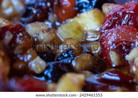 A macro closeup image of small pieces of fruit and spices ready for Christmas Mince Pies. Light shines off the liquid content of the mix. Stock photo © 