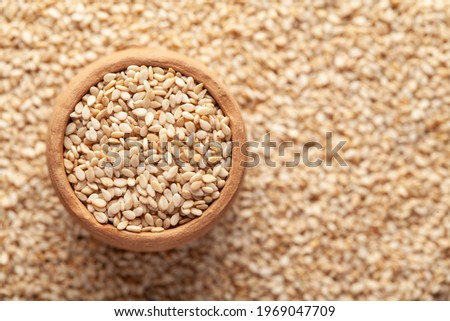 Macro Close-up of Organic White Sesame seeds(Sesamum indicum) or white Til in an earthen clay pot (kulhar) on the self background. Top view
