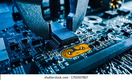 Macro Close-up Shot of Factory Machine at Work: Printed Circuit Board Being Assembled with Robotic Arm, Surface Mounted Technology Connecting Microchips, CPU Processor to the Motherboard. - Shutterstock ID 1705507807