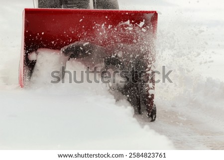 macro close-up of snow blower propeller churning, turning and throwing snow with motion. winter season snowstorm blizzard empty blank background with space for copy.
