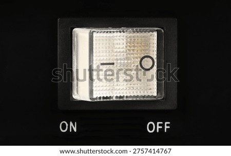 Macro close-up of a transparent rectangular power switch set to the 