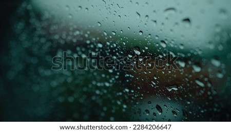 macro closeup water Raindrops sliding on the window glasses surface