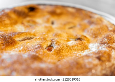 Macro Closeup Of Whole Apple Pie Baked Dessert With Fruit Filling And Shape Holes In Golden Crust Texture