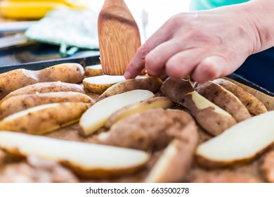 Macro Closeup Of Womans Hands Flipping Or Turning Over Plain Baked Potato Wedge Fries