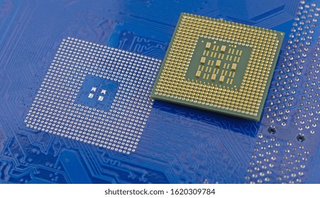macro of computer processor on blue motherboard circuit