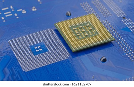 macro of computer processor on blue motherboard circuit